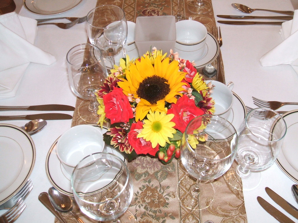 That small centerpiece uses just a few flowers but with vibrant colors that